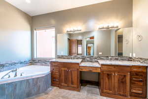 Dual wood-finish vanities with undermount sinks and light-toned countertops, featuring an integrated makeup vanity