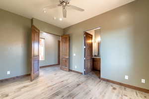 Spacious room featuring wood-finish flooring, warm olive walls, and a recessed window
