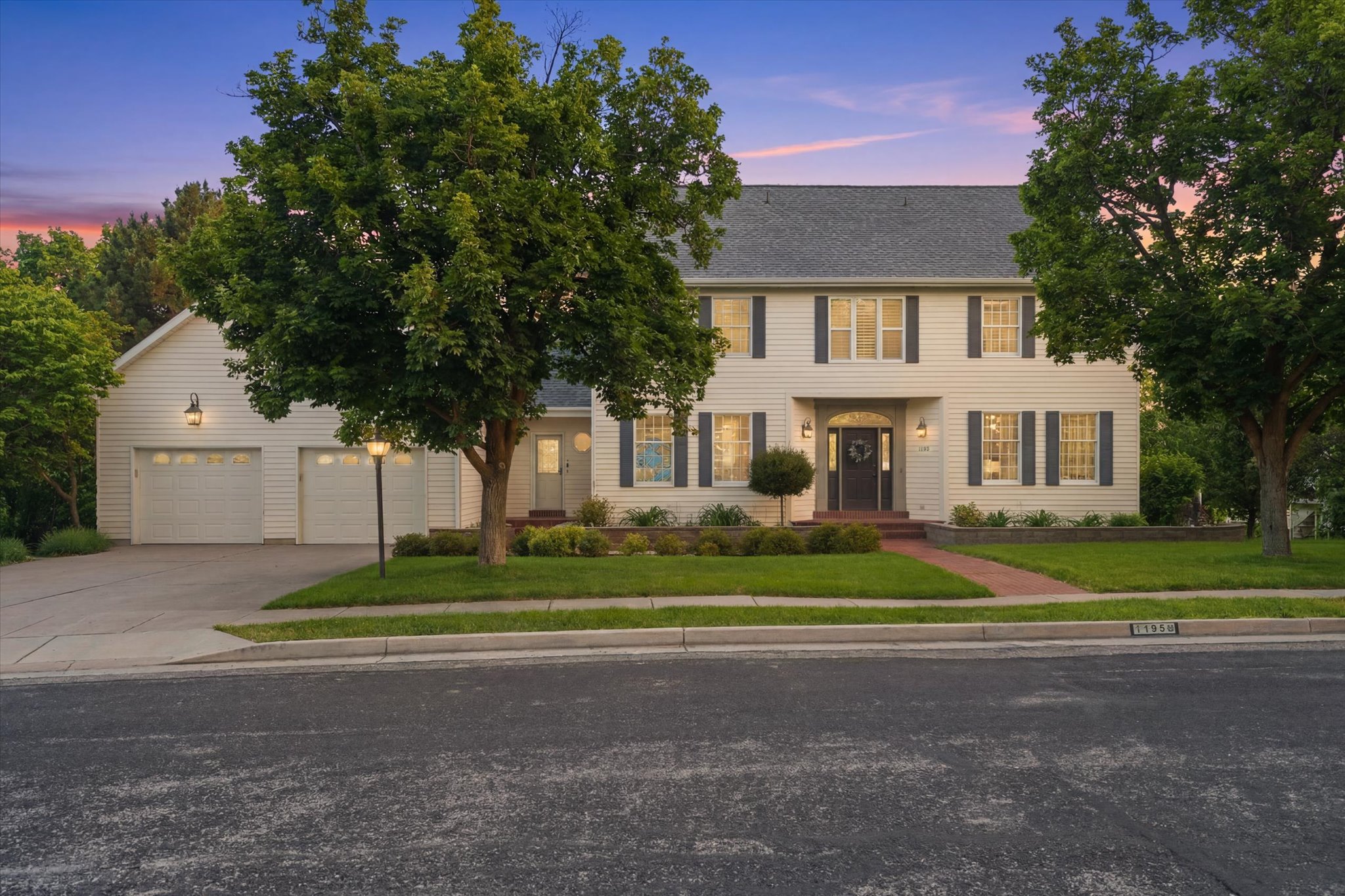 Two-story exterior with light siding and dark shutters