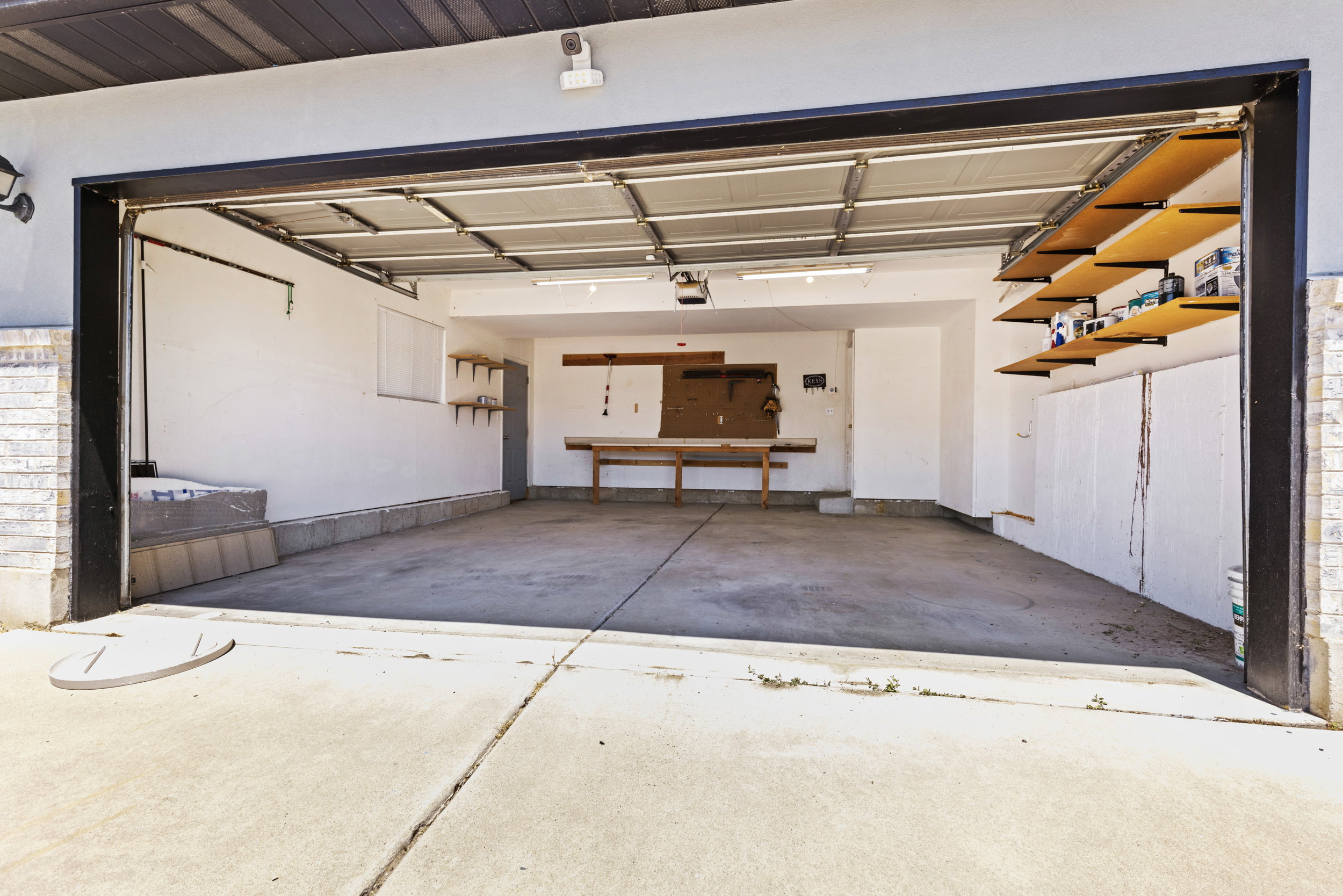 Two-car garage with a concrete floor and white painted walls
