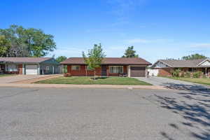 Brick exterior with a single-car garage and a paved driveway