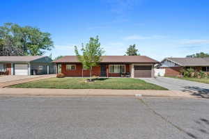 Brick facade ranch-style home with an attached single-car garage and a paved driveway