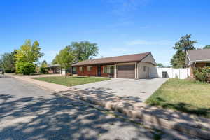 Ranch-style exterior with a combination of brick and siding, featuring a two-car garage