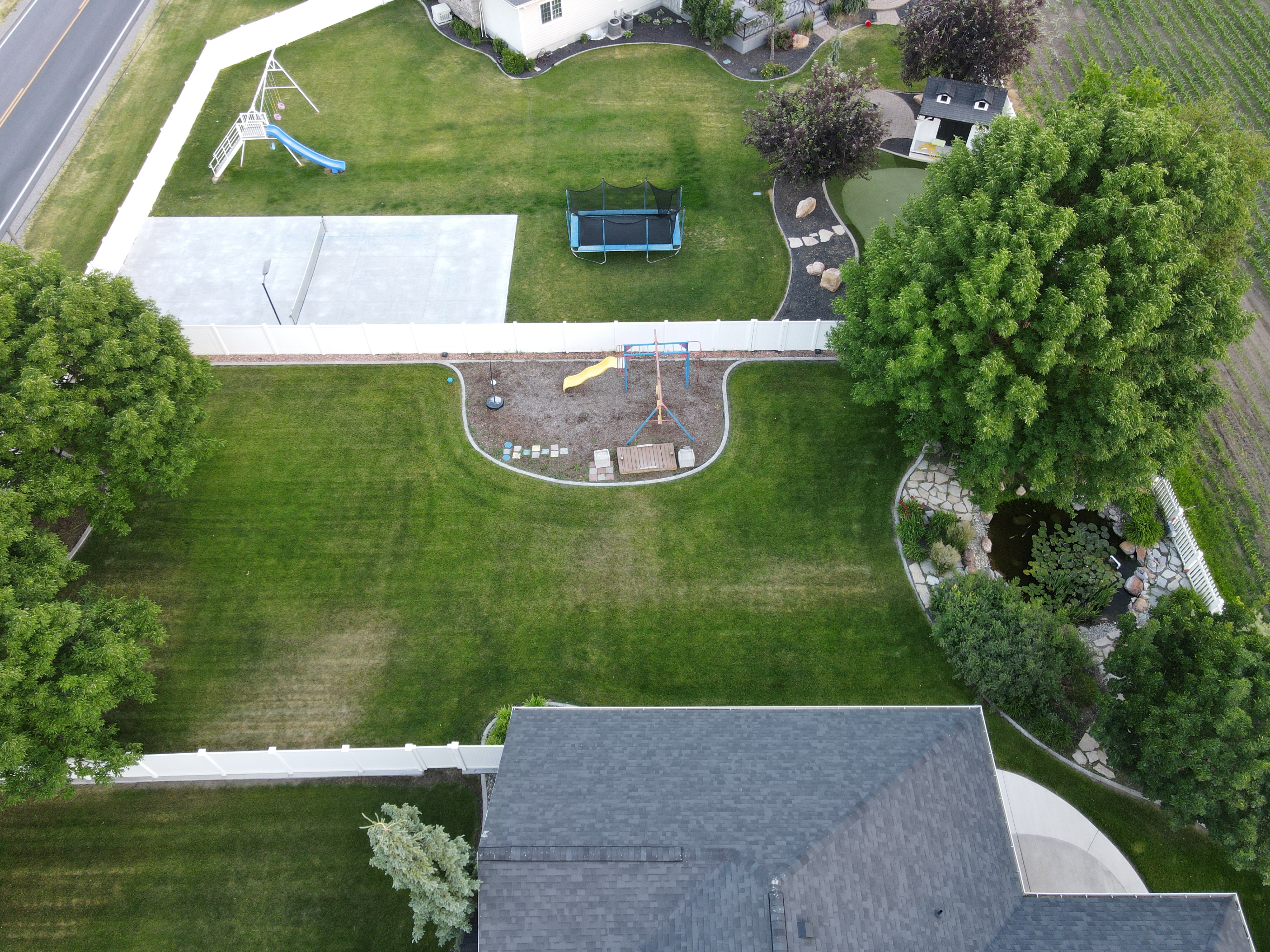 Side yard with play ground and pond