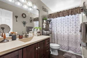 Bathroom featuring a vanity with a light-toned countertop and dark wood-finish cabinetry