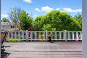 Spacious outdoor deck featuring composite decking and a white railing system