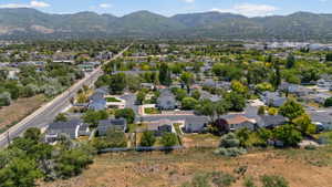 Residential area featuring a variety of homes, mature trees, and mountainous terrain in the background
