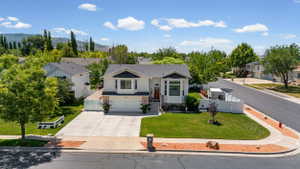 Two-story residence featuring a bay window, a dual-car garage, and a concrete driveway