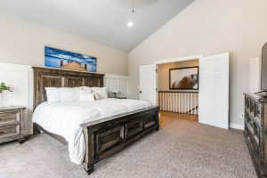 Vaulted ceilings compliment this carpeted room featuring wainscoting and neutral wall tones