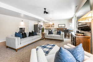 Open-concept living space featuring neutral wall tones, recessed lighting, and a modern ceiling fan