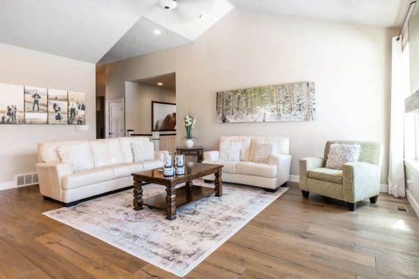 Living area featuring vaulted ceilings, wood-finish flooring, and recessed lighting