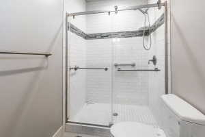 Walk-in shower with clear glass enclosure and sliding door