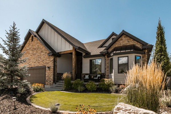 Stone and siding exterior with dark trim accents