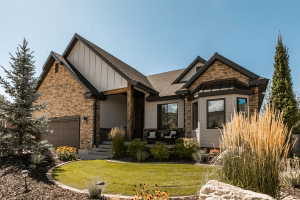Stone and siding exterior with dark trim accents