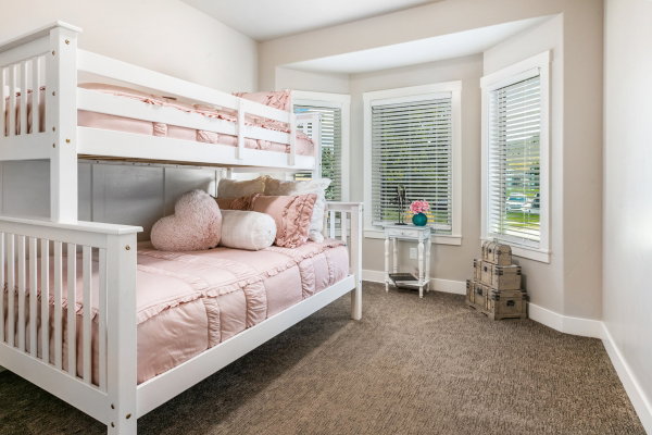 Bay window featuring three large windows with blinds