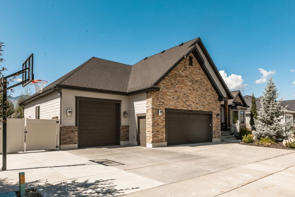 Contemporary exterior featuring a stone facade and horizontal siding