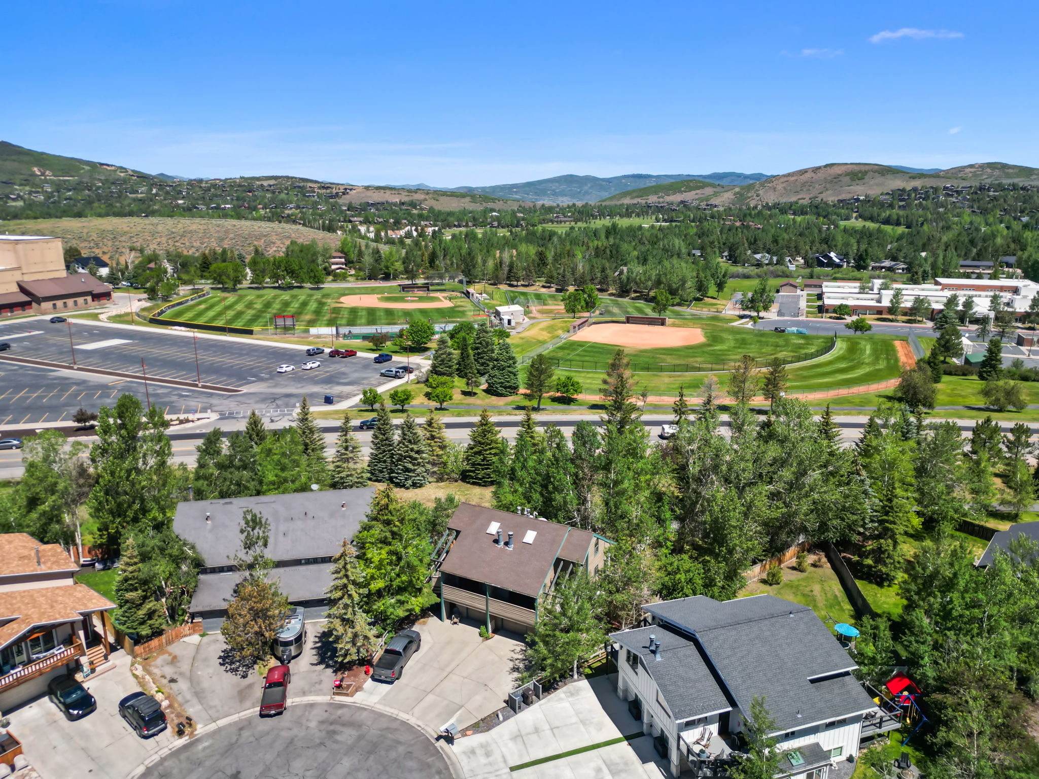 Aerial perspective showcasing proximity to multi-field sports complex and expansive paved parking