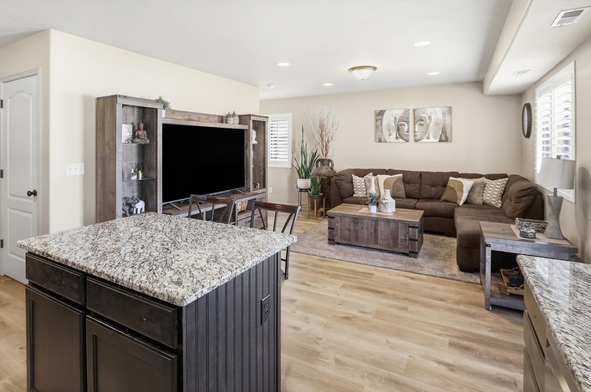 Kitchen island featuring a speckled countertop and beadboard paneling