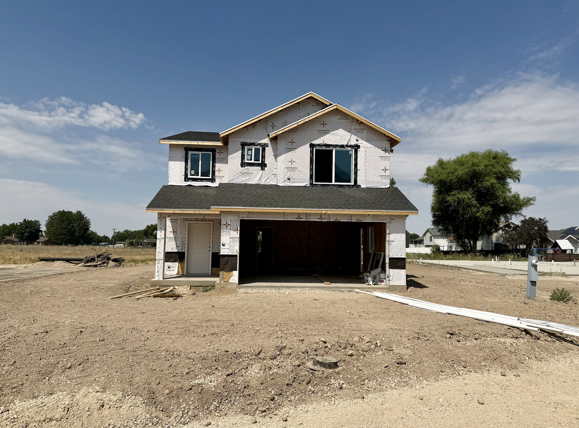 New construction home featuring a two-story design, attached two-car garage, and a covered entry
