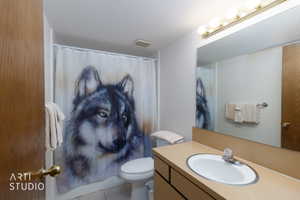 Bathroom featuring a built-in vanity with an integrated sink, a large wall-mounted mirror, and overhead strip lighting