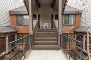 Multi-level exterior featuring brick and siding accents