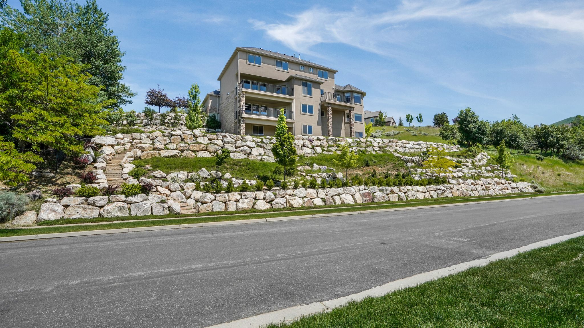 Multi-level residence featuring a stucco exterior and multiple balconies