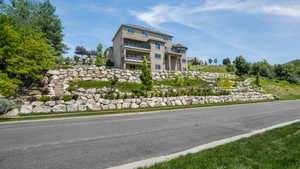 Multi-level residence featuring a stucco exterior and multiple balconies
