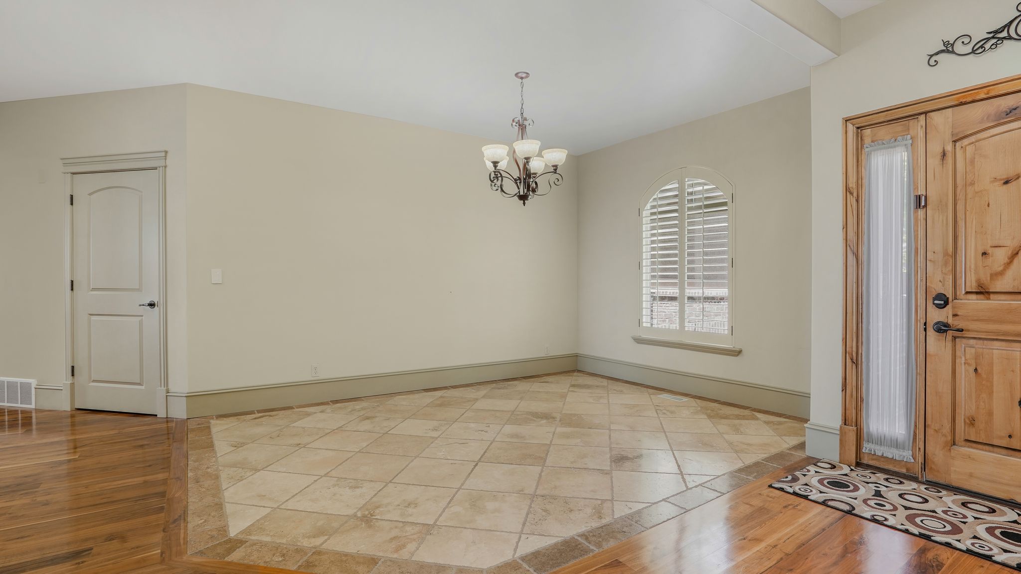 Entryway featuring double wood-paneled doors with frosted glass inserts
