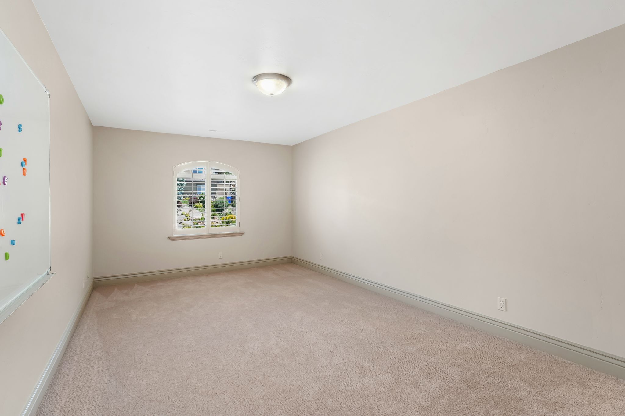 Light beige carpeting extending throughout the room