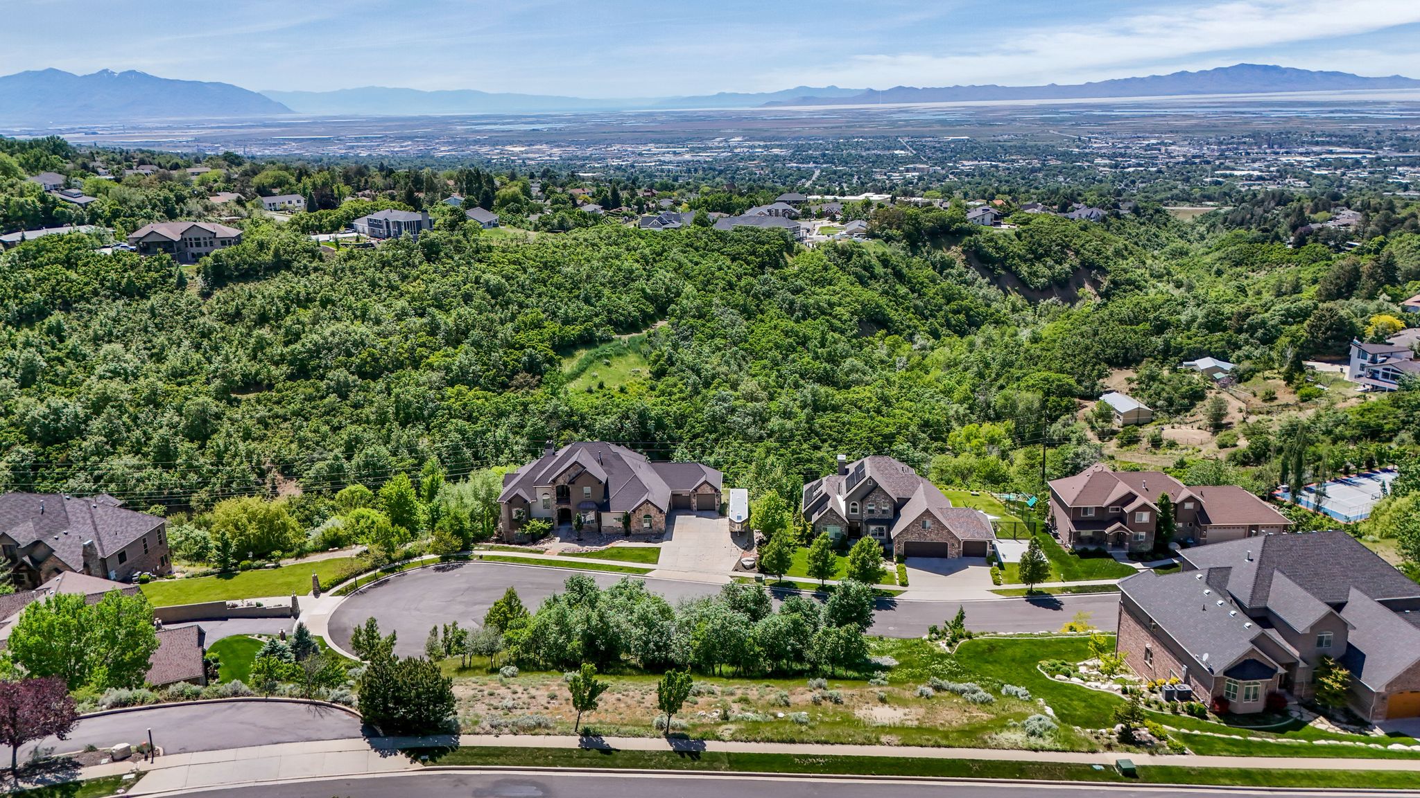 Elevated property showcasing a mountain backdrop and expansive green landscape