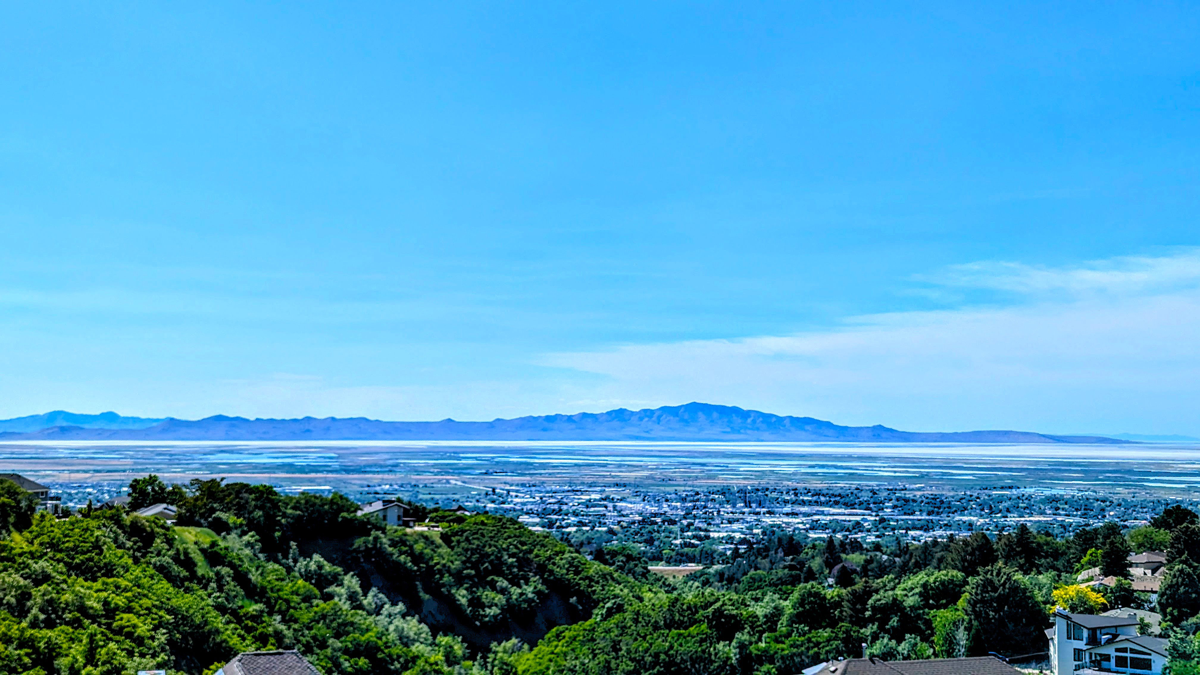 Expansive elevated scenery featuring distant mountains and a vast body of water