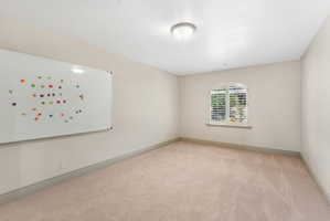 Neutral tone walls with an arched window featuring plantation shutters