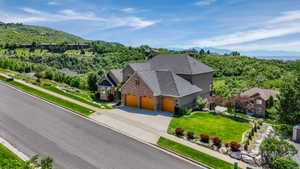 Expansive residential property featuring a multi-level design, brick and stucco exterior, and a three-car garage