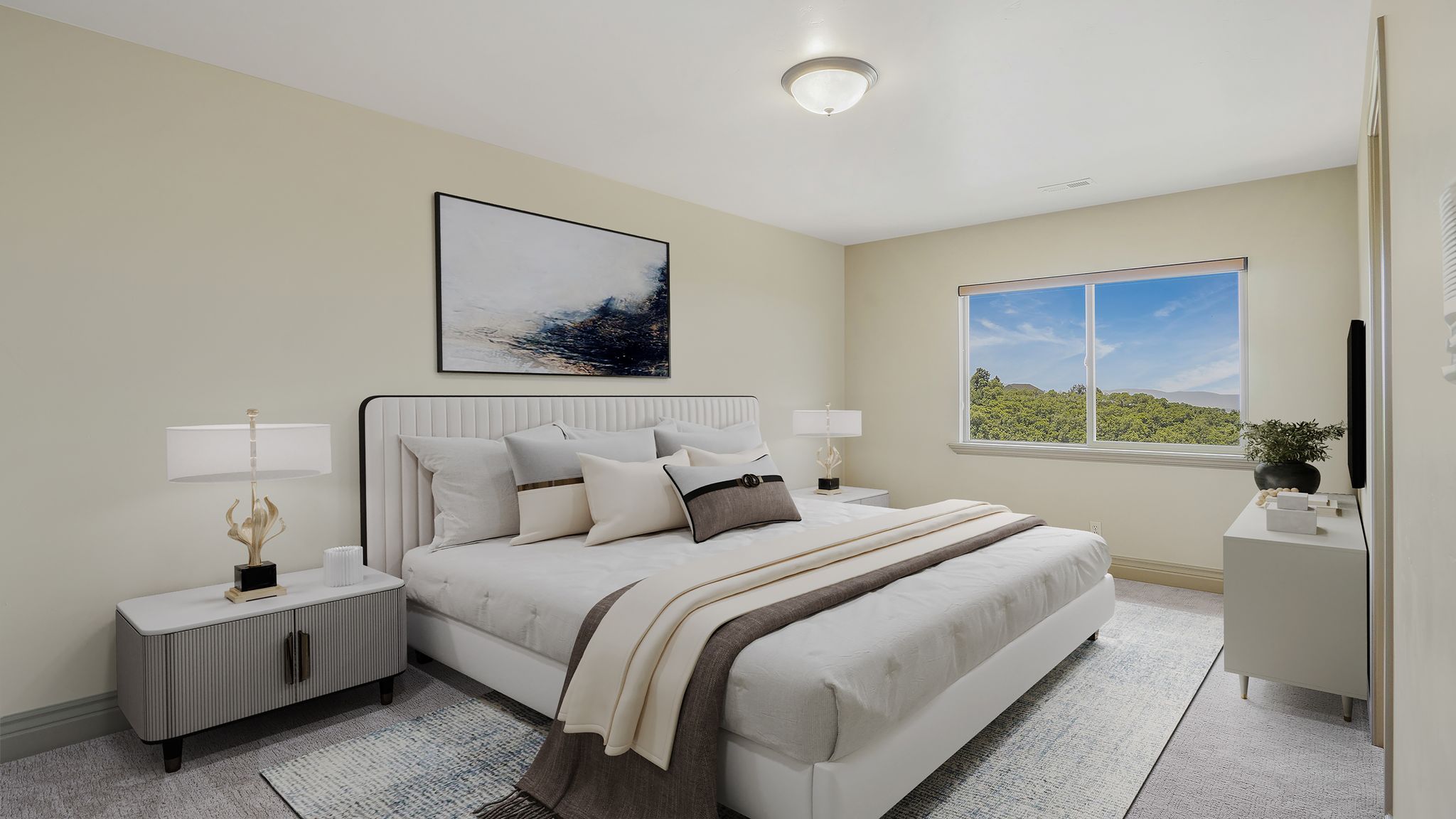 Bedroom with neutral wall tones and a window framing a natural landscape