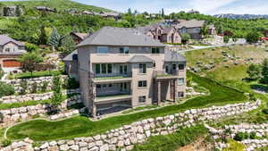 Terraced hillside property featuring extensive rock retaining walls and manicured green spaces