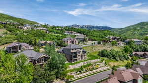 Lush green hillside setting with a paved roadway and extensive rock retaining walls