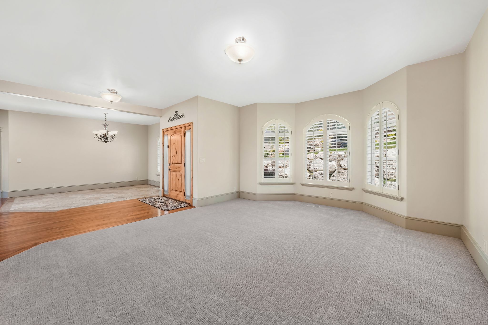 Bay window with arched frames and plantation shutters