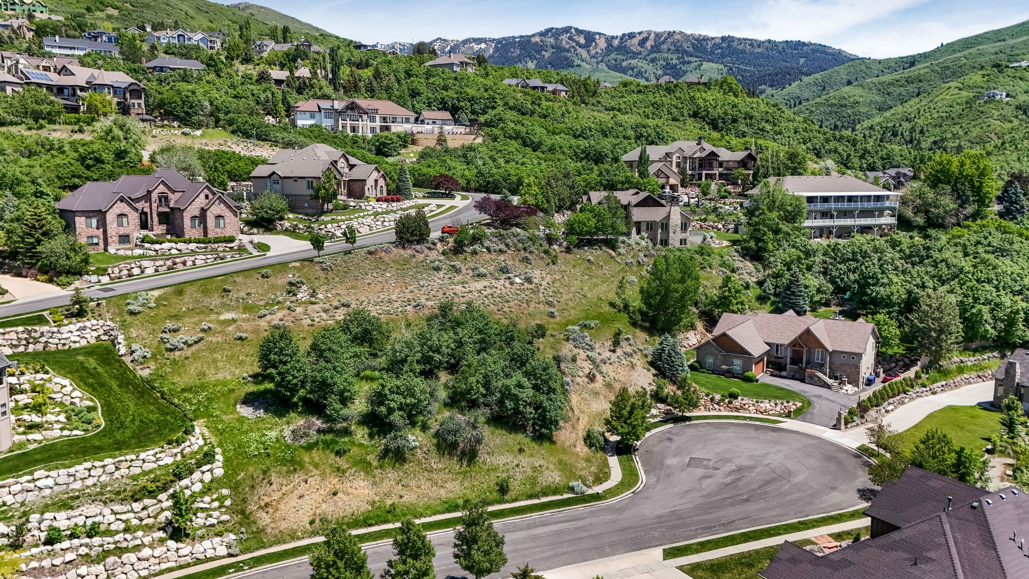 Hillside residential setting featuring paved streets and established homes