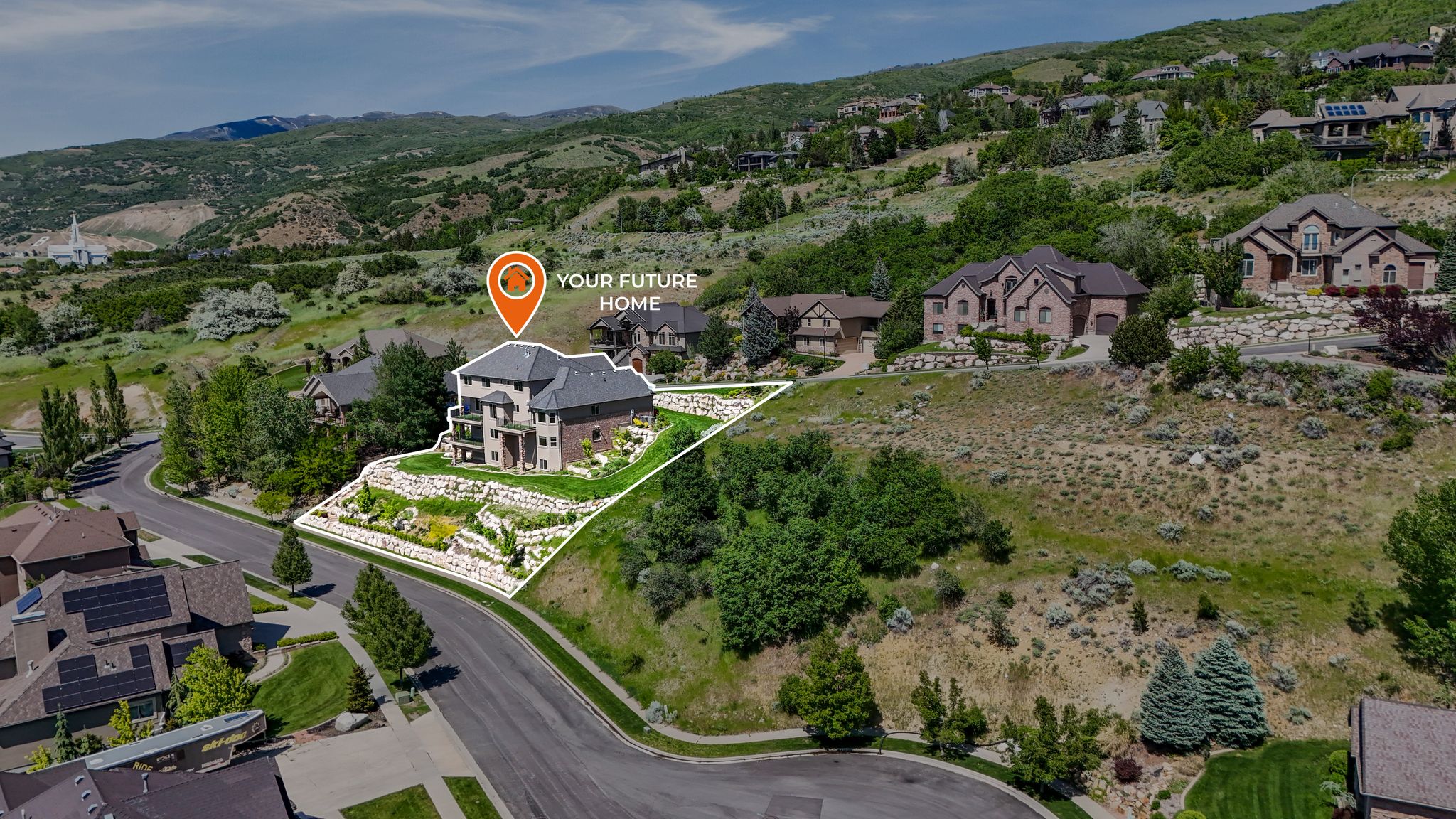 Hillside property featuring a multi-story residence with a stone and brick exterior