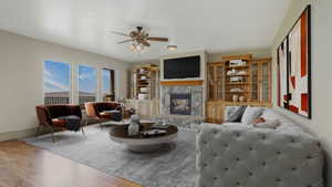 Living space featuring wood-finish flooring and a central area rug