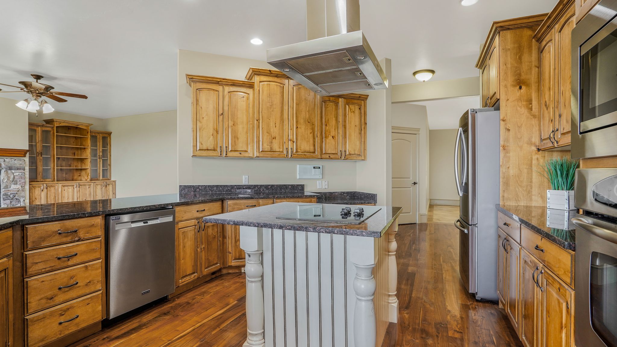 Kitchen featuring wood-finish cabinetry, dark countertops, and stainless steel appliances