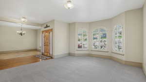 Spacious entry area with light-toned walls and contrasting floor finishes