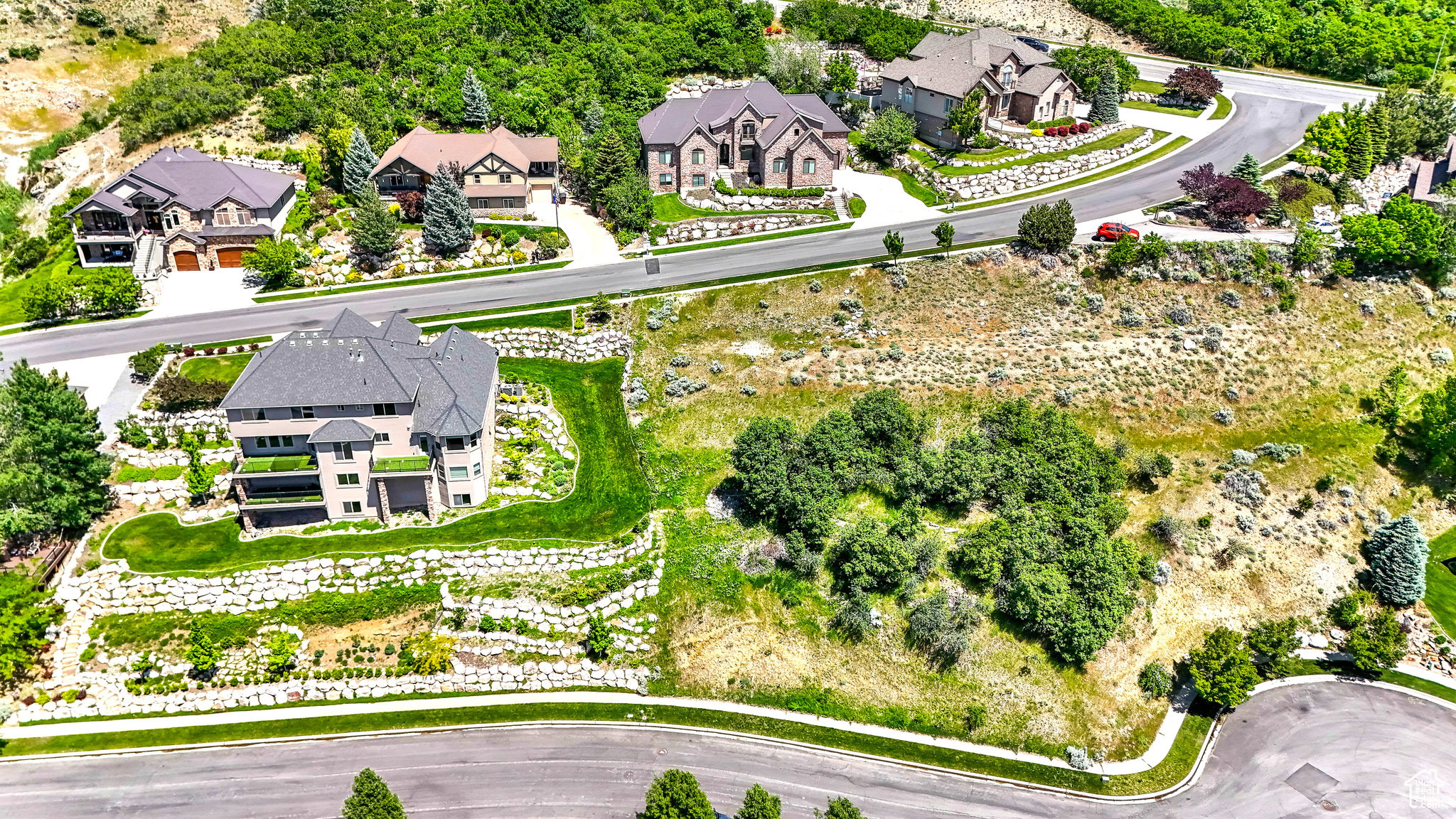 Terraced hillside property with extensive retaining walls and manicured lawn areas
