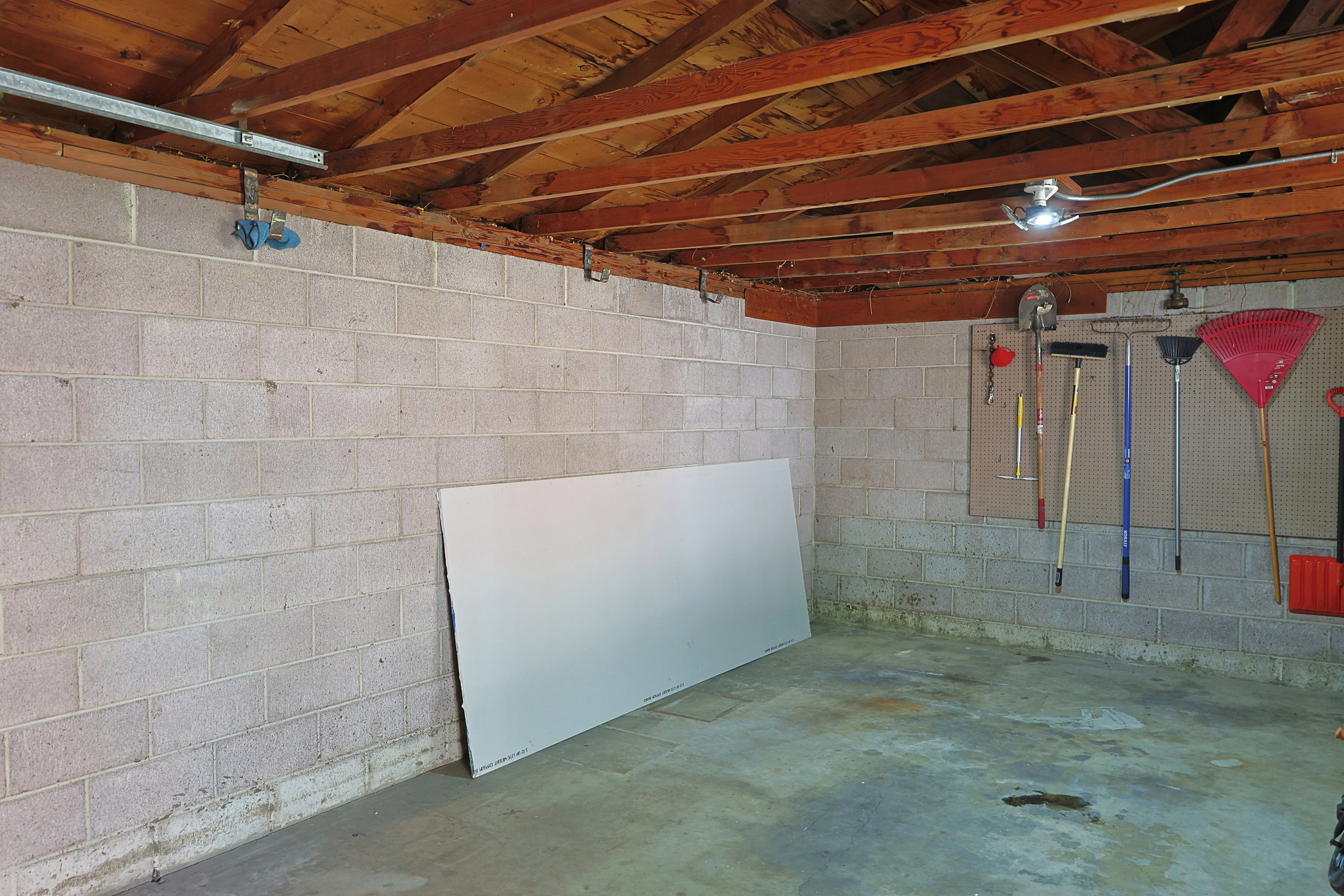 Garage solidly built with concrete block walls and brick exterior.