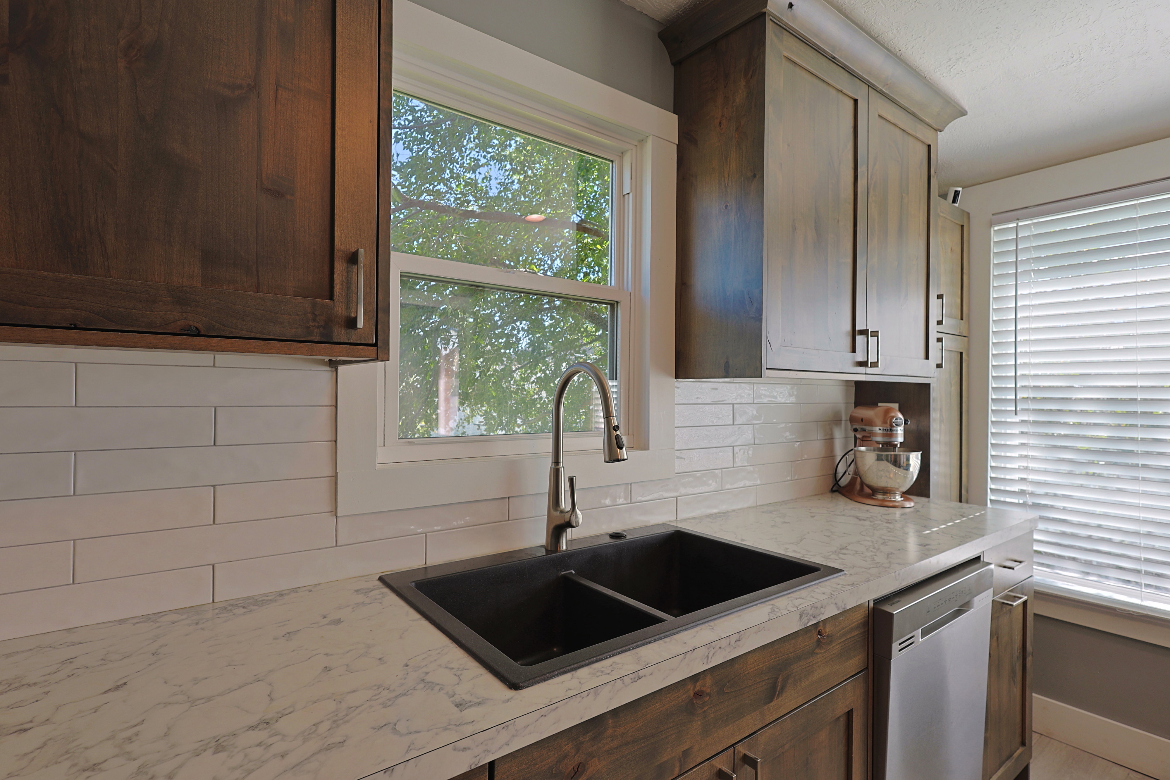 Kitchen workspace featuring a dual-basin black sink with a gooseneck faucet