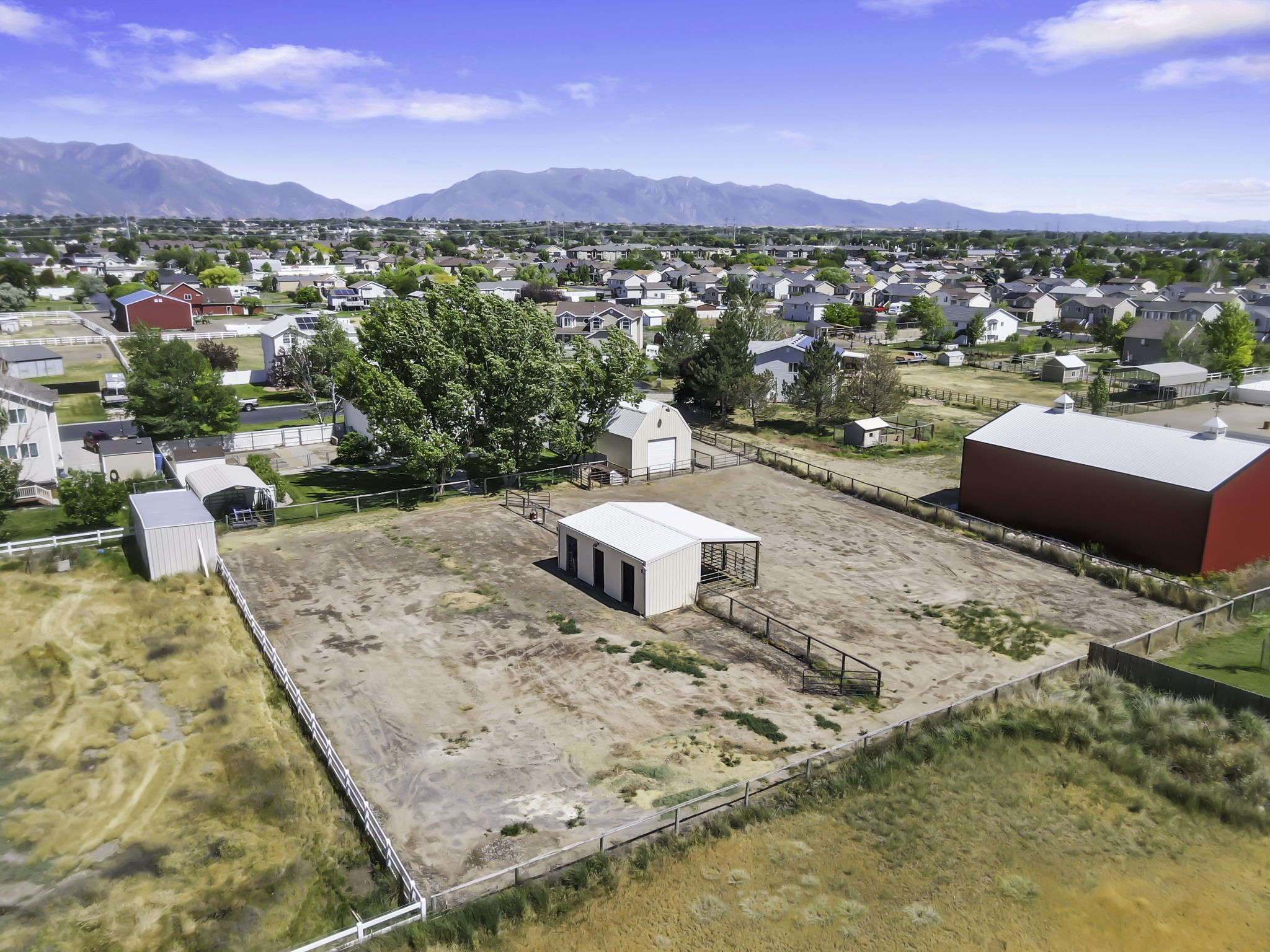 The total package, horse property on 1 Acre with secondary water, horse pasture with automatic sprinklers, 3 stall horse shelter, barn, large lush backyard , raised planting beds, chicken coop, sheltered  dog run and fire pit.