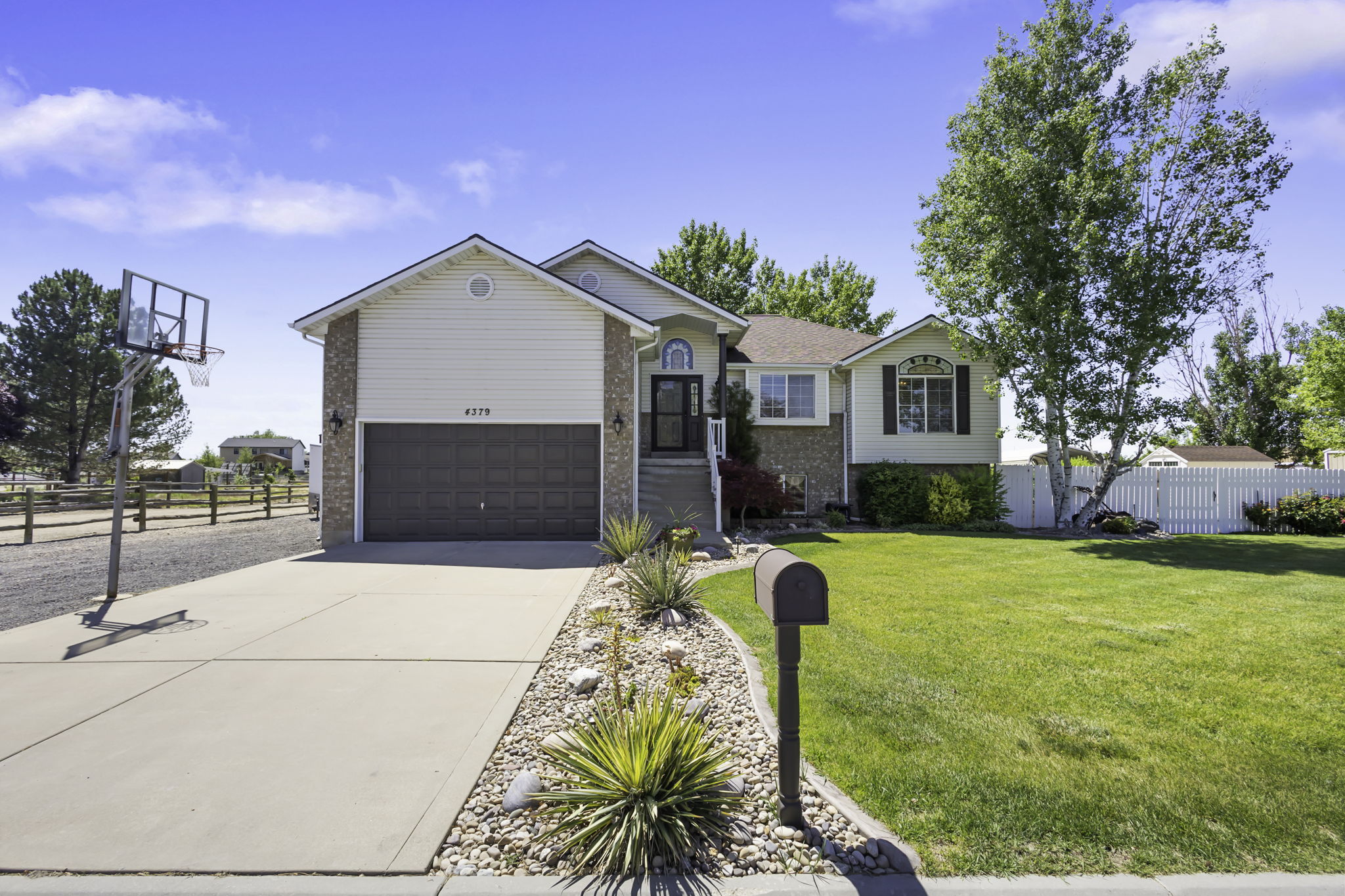 Raised Ranch Rambler featuring a two-car garage with extra storage in the upper portion of the Garage