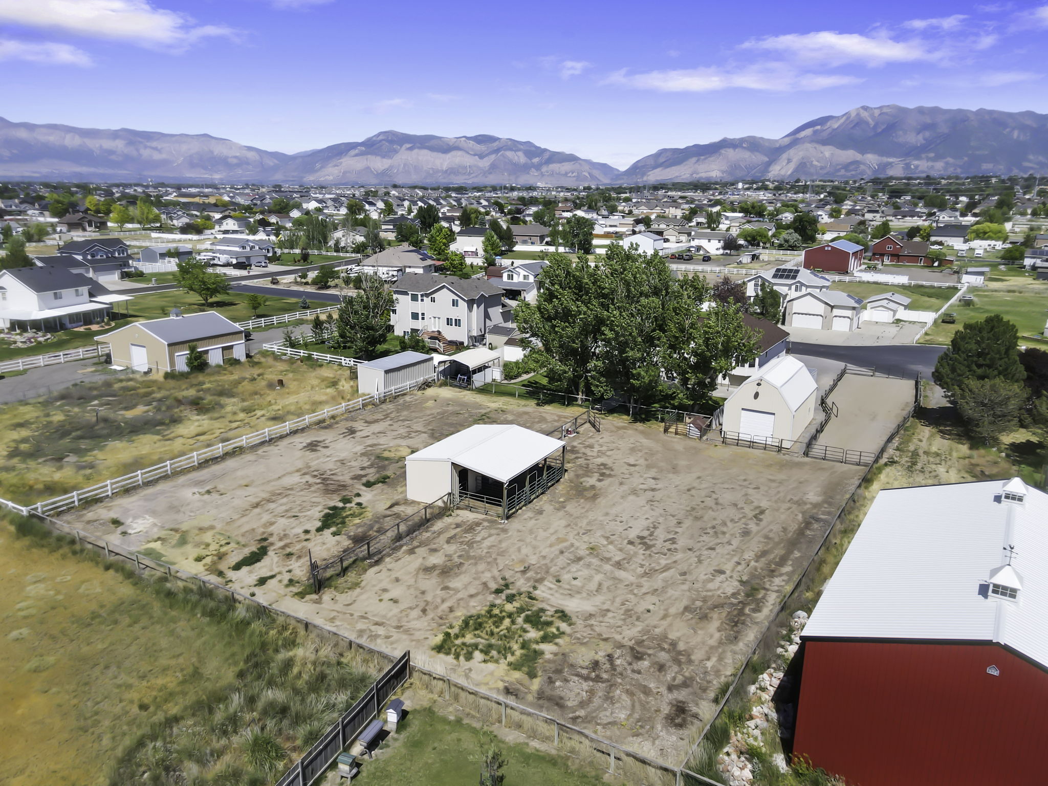 The total package, horse property on 1 Acre with secondary water, horse pasture with automatic sprinklers, 3 stall horse shelter, barn, large lush backyard , raised planting beds, chicken coop, sheltered  dog run and fire pit.