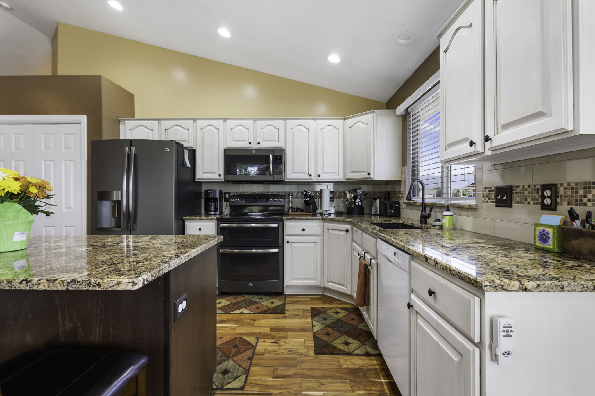 Kitchen featuring abundant cabinetry, granite countertops,  and stainless steel refrigerator microwave and double oven