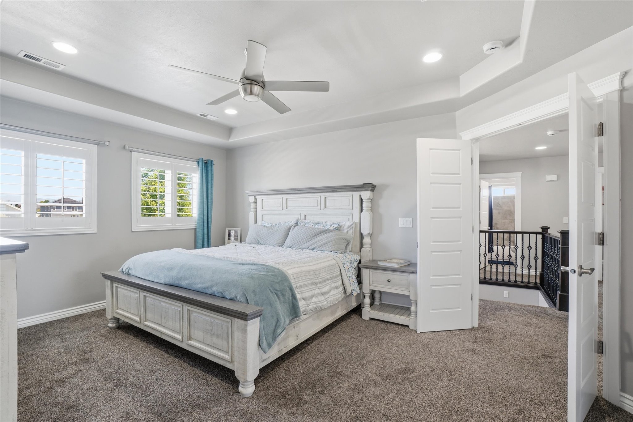 Plush carpeting throughout with white plantation shutters and recessed lighting